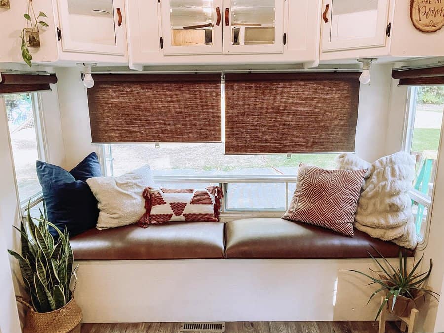 Cozy RV seating area with plush pillows and natural light