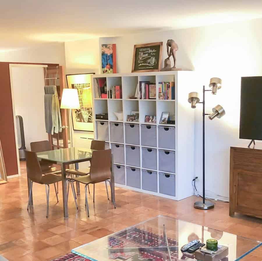 A modern living space with a cube storage unit, fabric bins, and open shelves for a stylish and functional organization solution