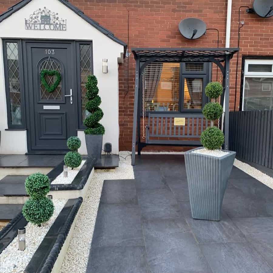 Entryway with topiaries and swing bench