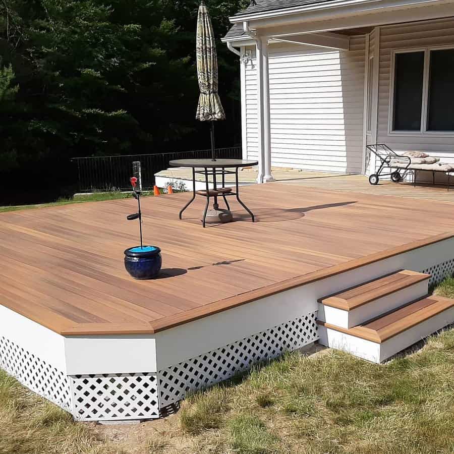 Spacious deck with lattice skirting and patio furniture