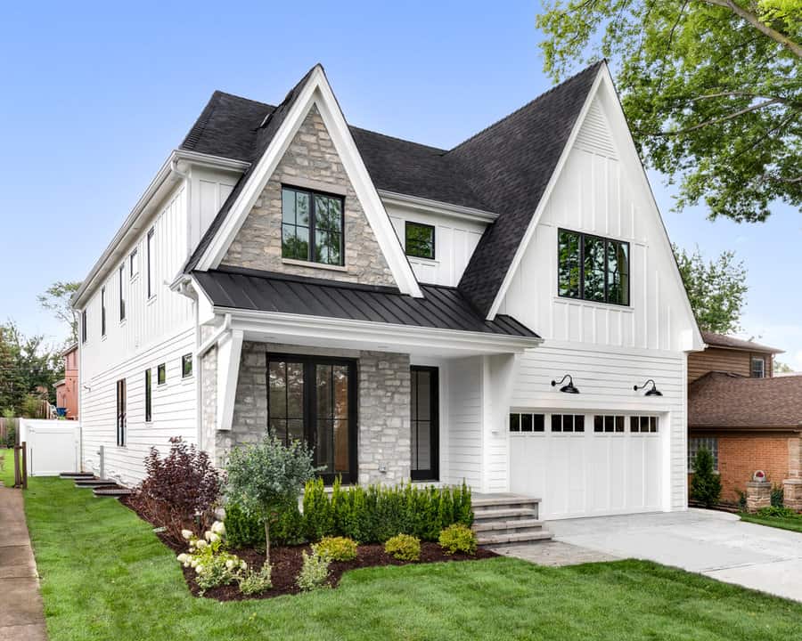 Modern white house with stone accents and tidy yard