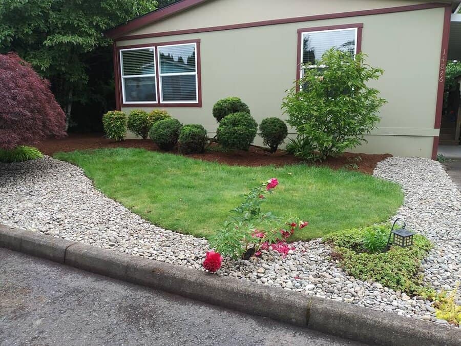 Home with green lawn and pebbles