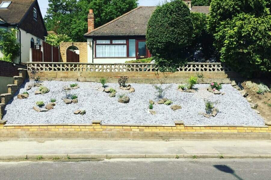 Front yard landscaping with white gravel