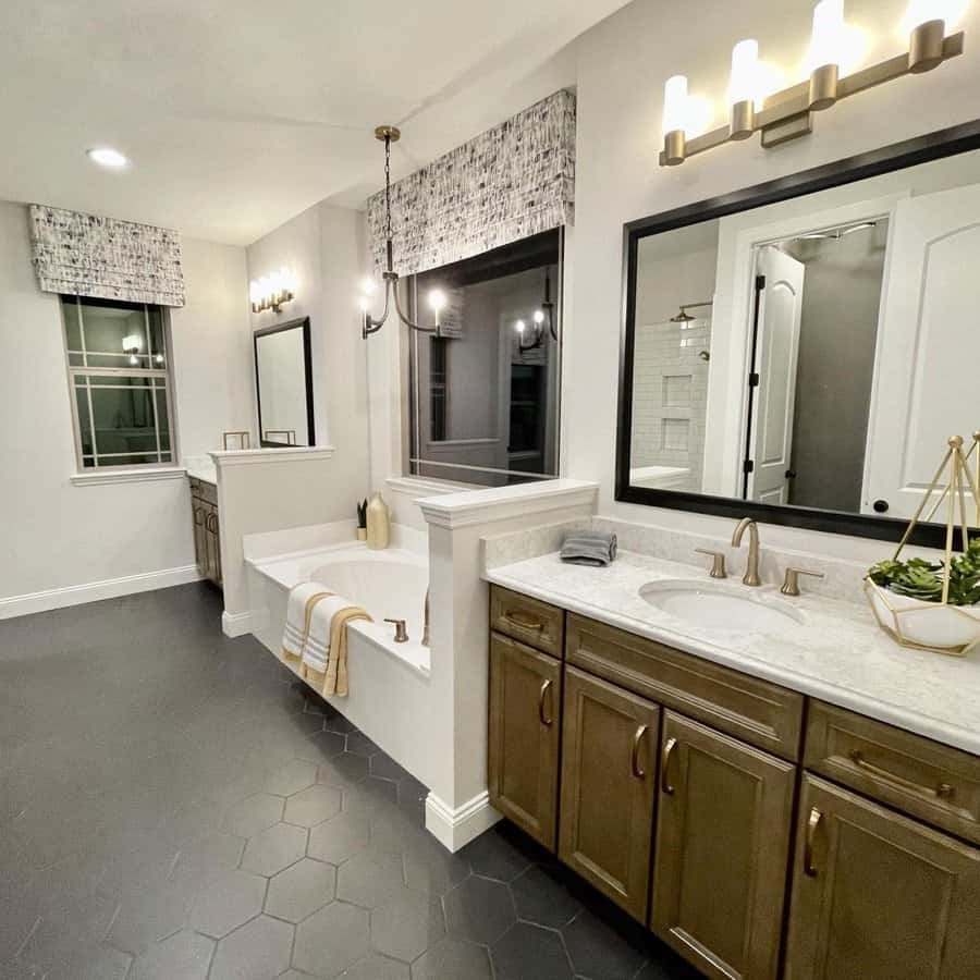 Luxurious bathroom with tub, vanity, and modern lighting