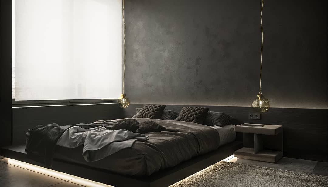 Minimalist black bedroom with a floating bed, quilted pillows, soft ambient lighting, and warm gold pendant lights