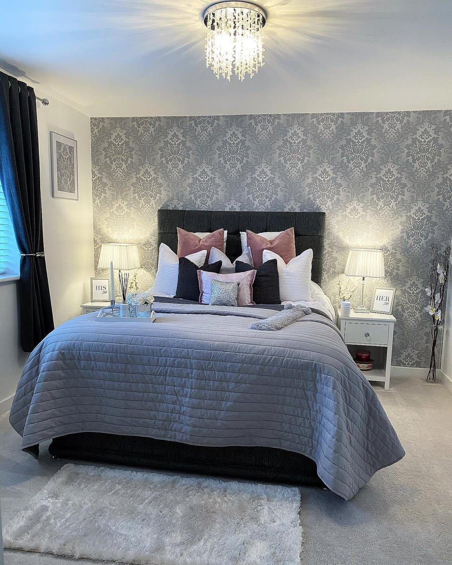 Elegant bedroom with damask wallpaper and sparkling chandelier