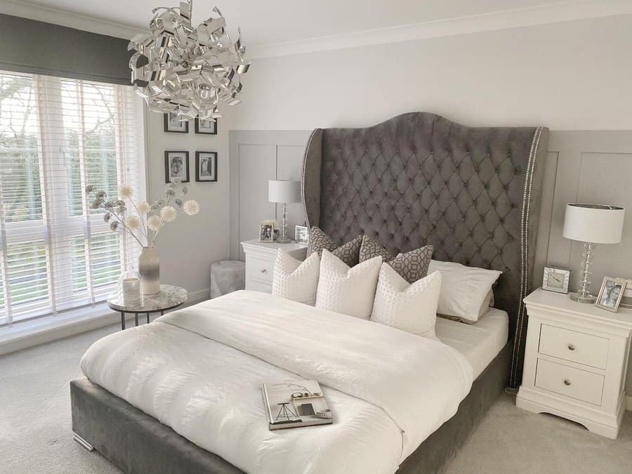 Luxurious bedroom with sculptural light fixture and plush headboard