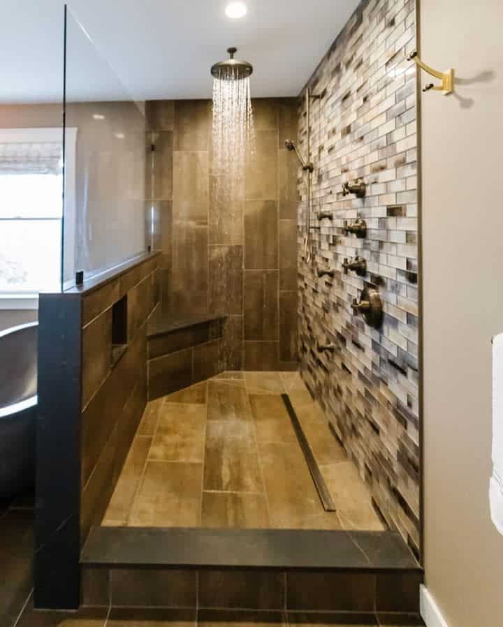 walk-in shower with mosaic tile accent