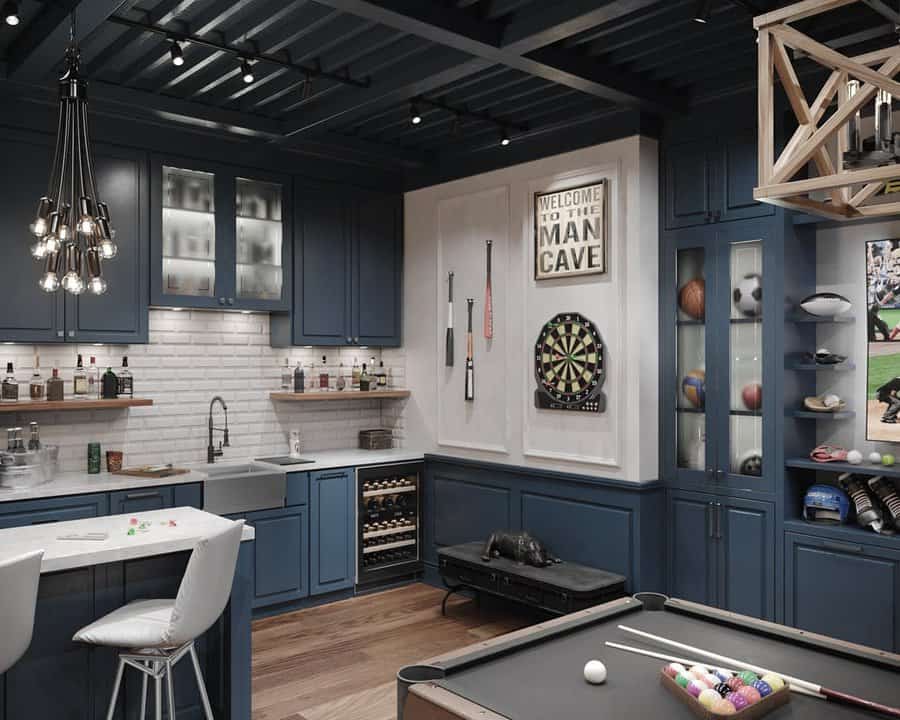 Sophisticated basement man cave with deep blue cabinetry, a built-in bar, dartboard, pool table, and sports memorabilia for the ultimate hangout space.