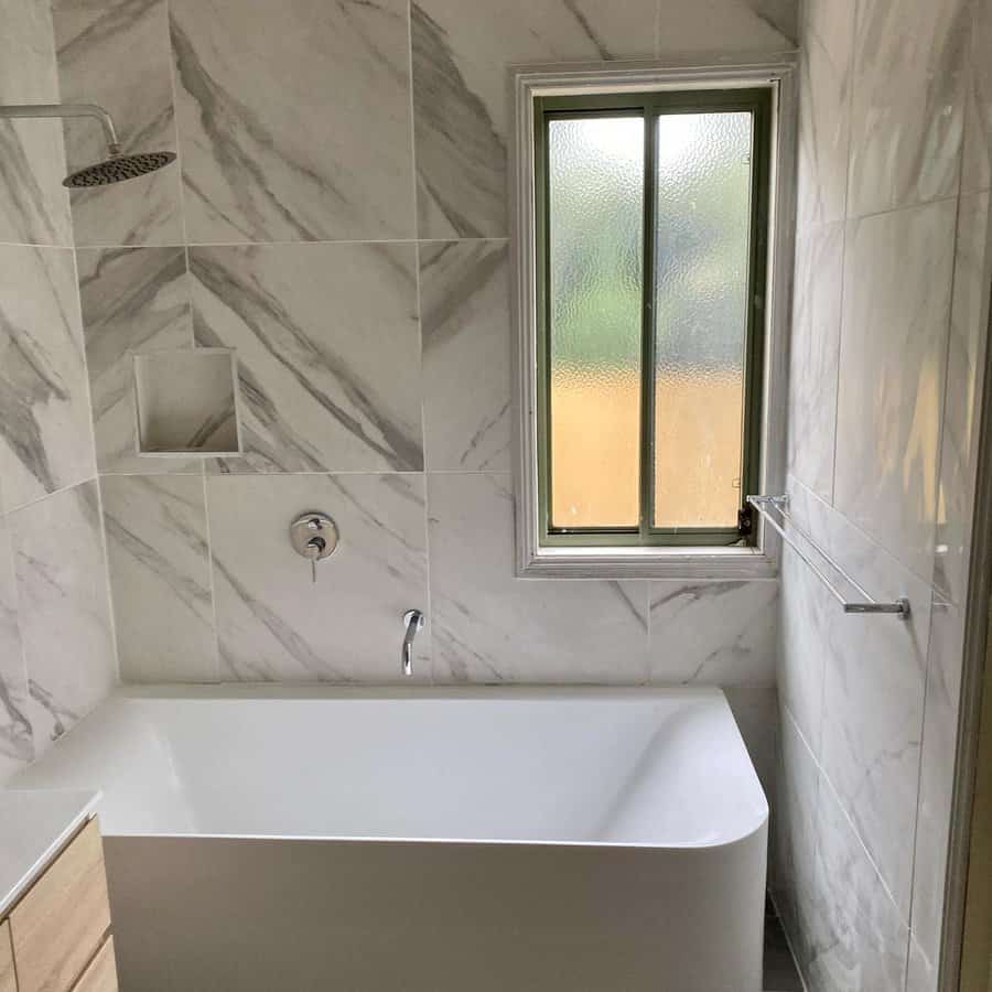 Marble tiled bathroom with frosted window