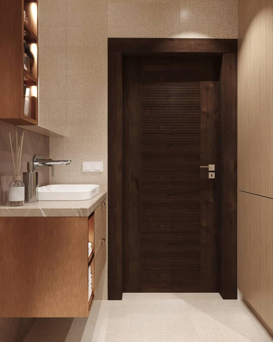 beige bathroom with dark wood fixtures 