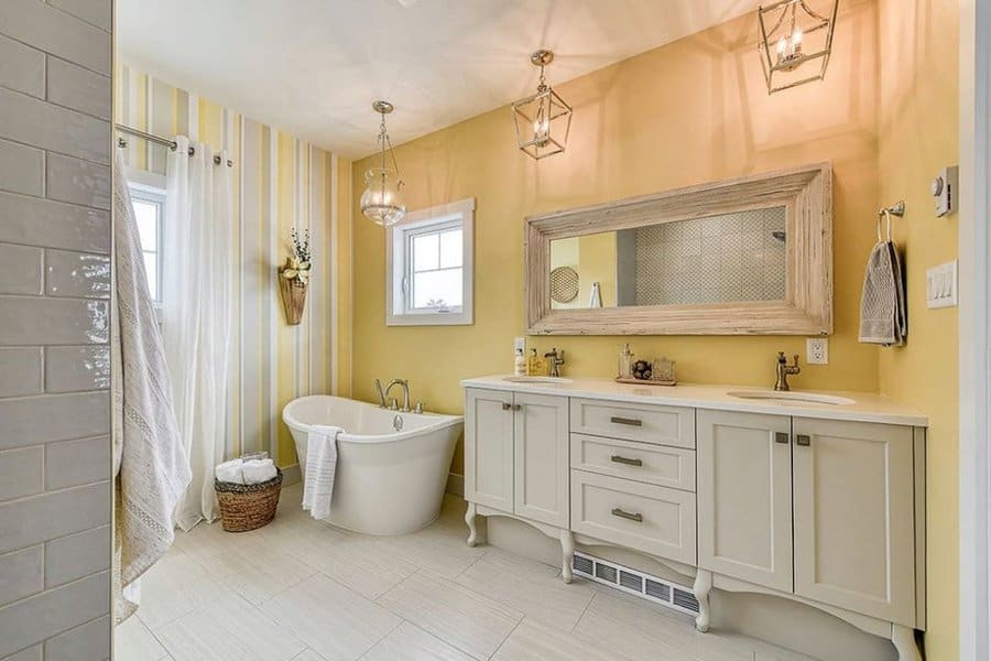 Warm bathroom with freestanding tub and pendant lights