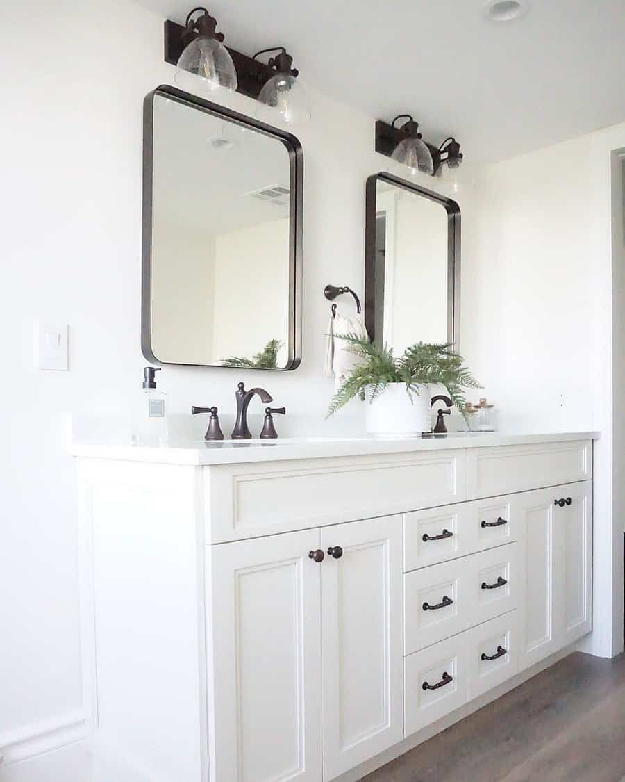 Fresh white bathroom with black accents and vanity lights