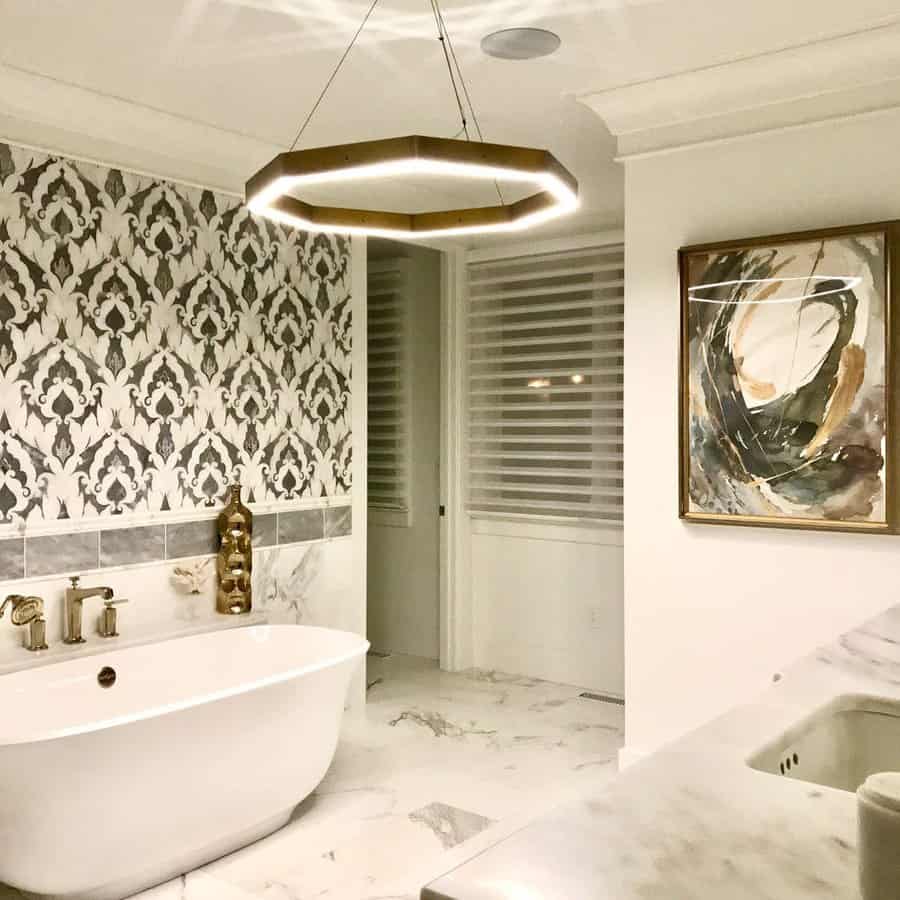 Luxury bathroom with patterned accent wall and unique light fixture