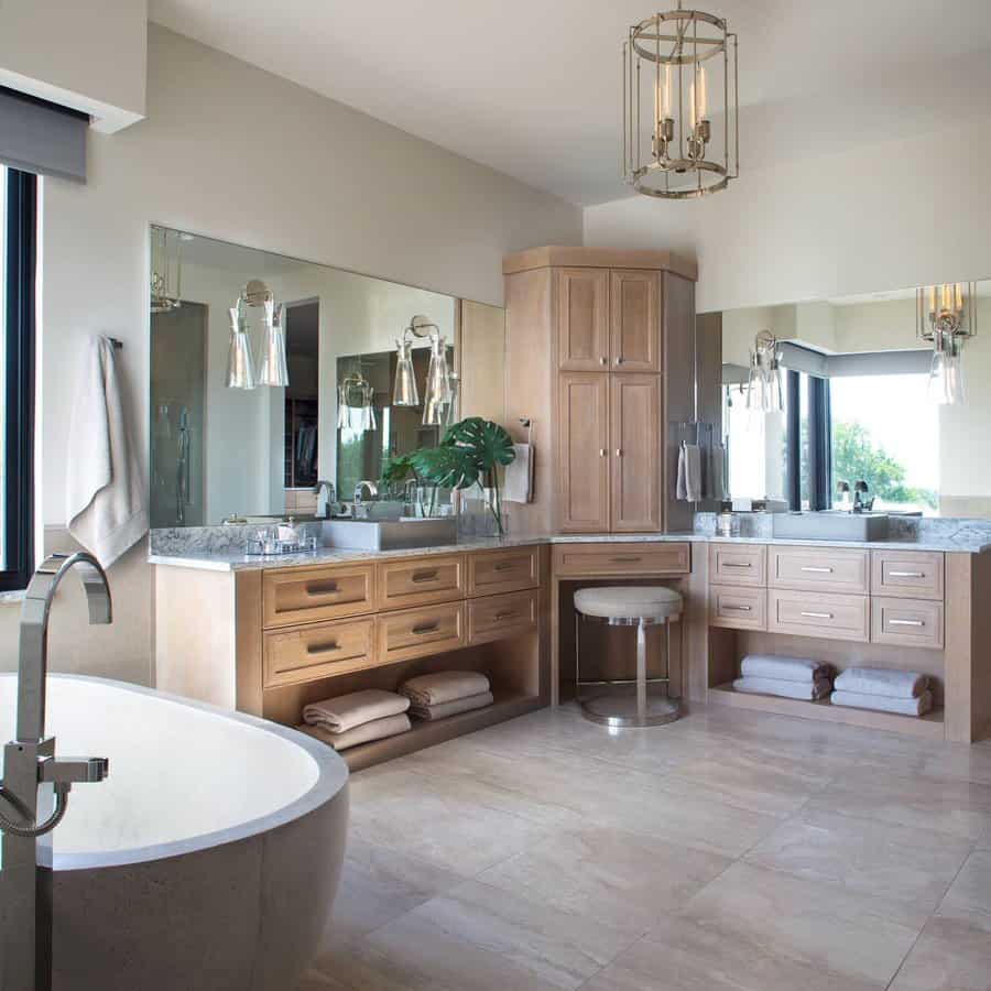 Elegant bathroom with wood cabinetry and pendant lighting