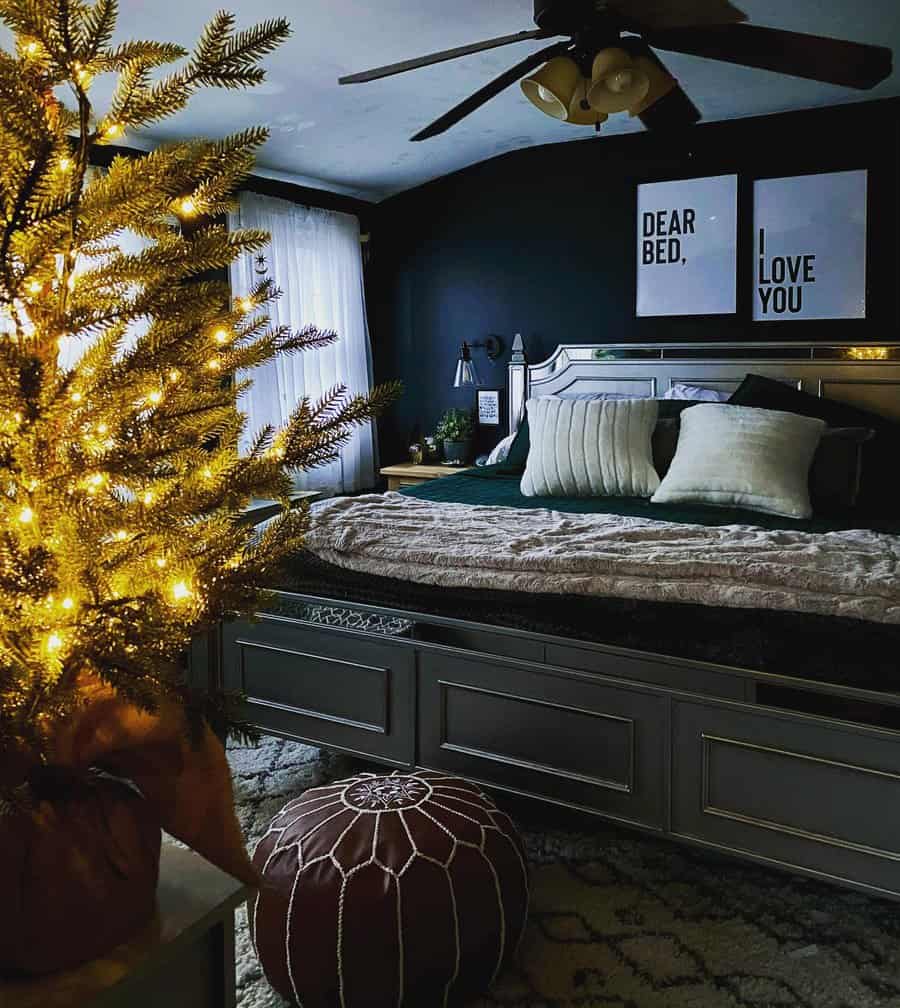 Festive bedroom with lit tree and humorous art