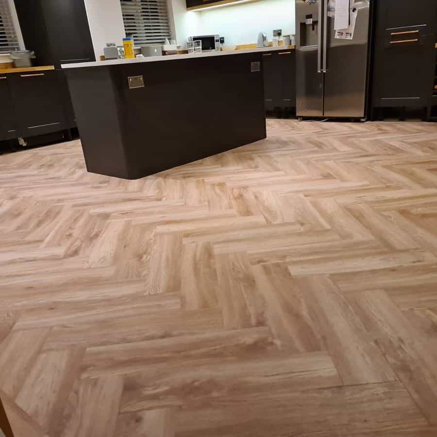 Kitchen with herringbone floor and a dark island