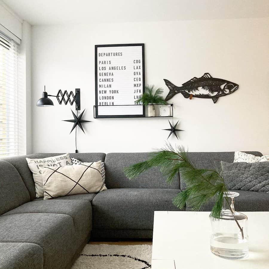 Living room with grey couch and fish wall hanging