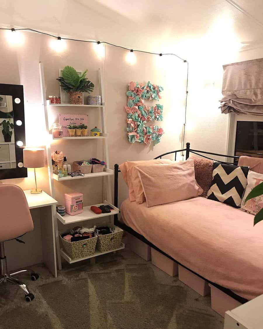 Chic metal daybed with soft pink bedding, string lights, and storage bins underneath, creating a cozy and stylish bedroom retreat