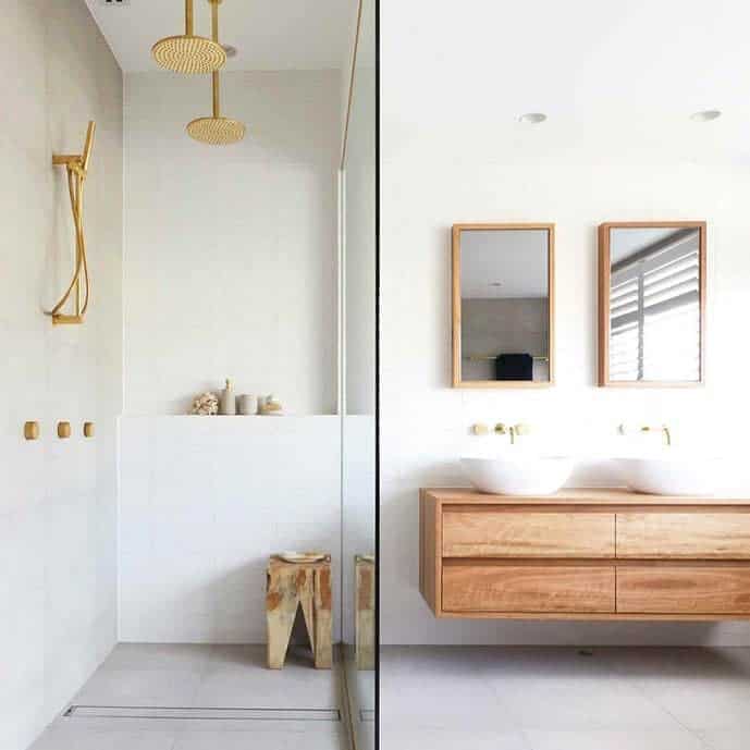 Modern bathroom with gold fixtures and wooden vanity