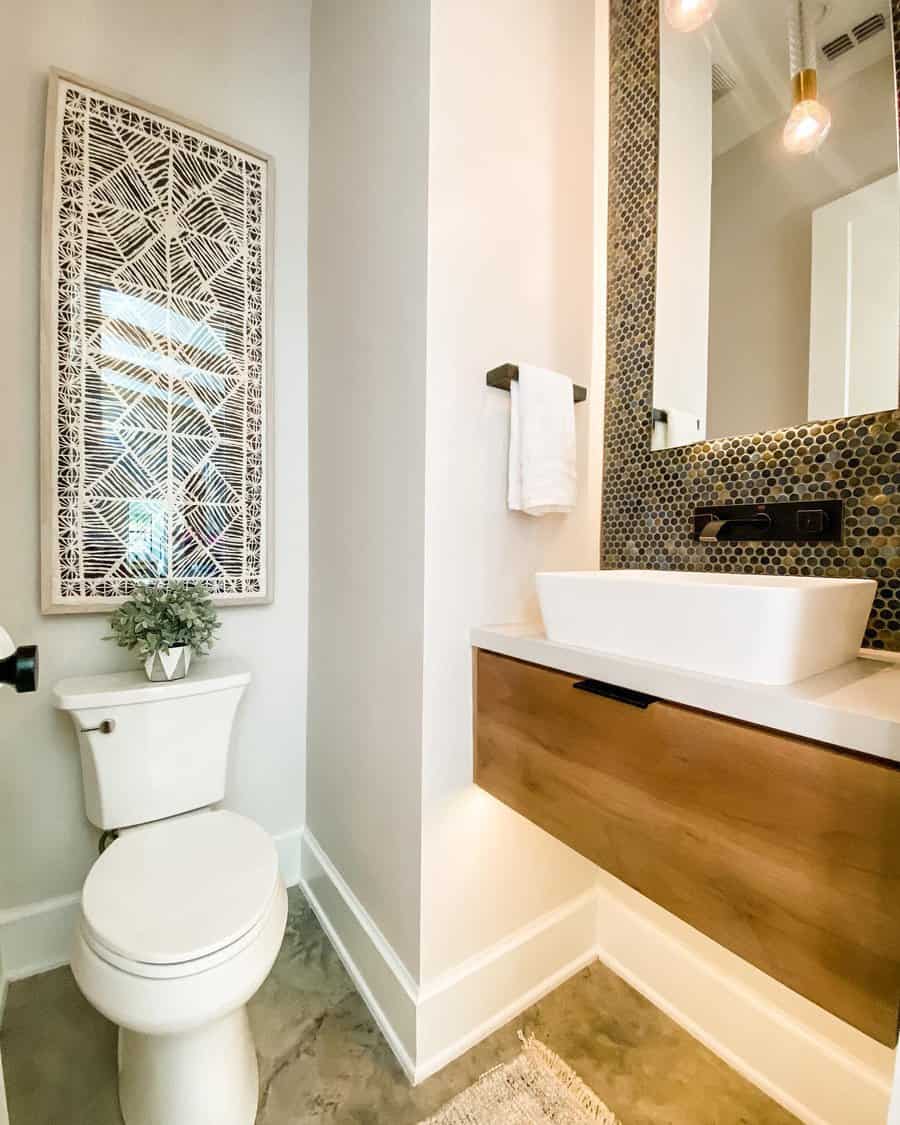 Contemporary bathroom with metallic penny tile backsplash, floating wood vanity, vessel sink, and warm lighting for a modern touch.