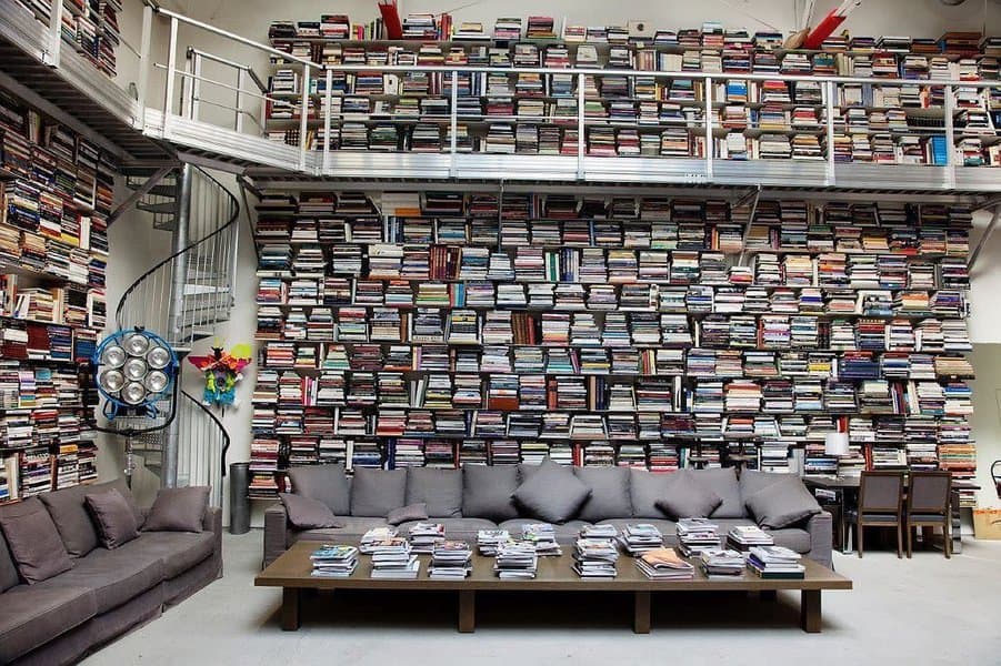 Room with ceiling high bookshelves and spiral staircase