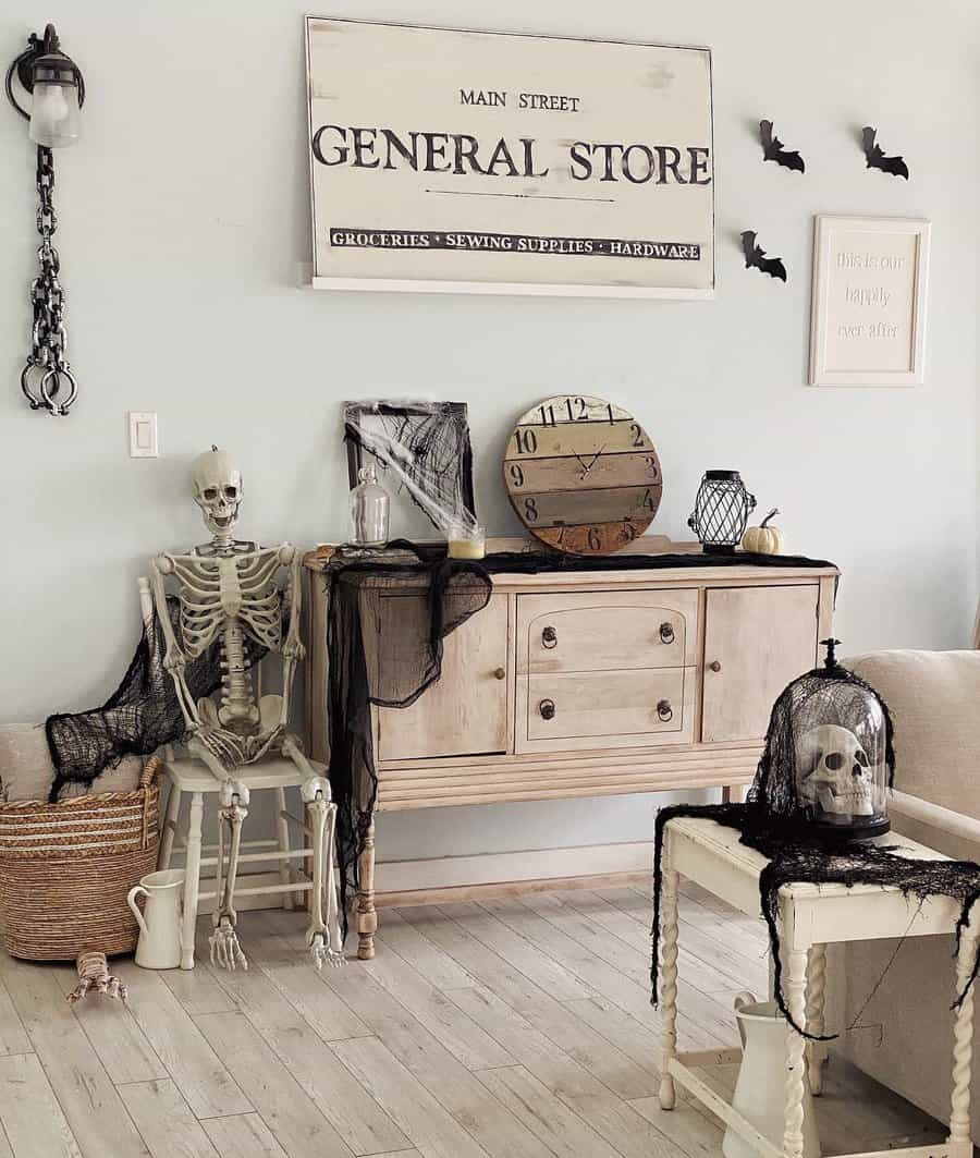 Halloween decorated room with a skeleton, skull, and cobwebs on furniture