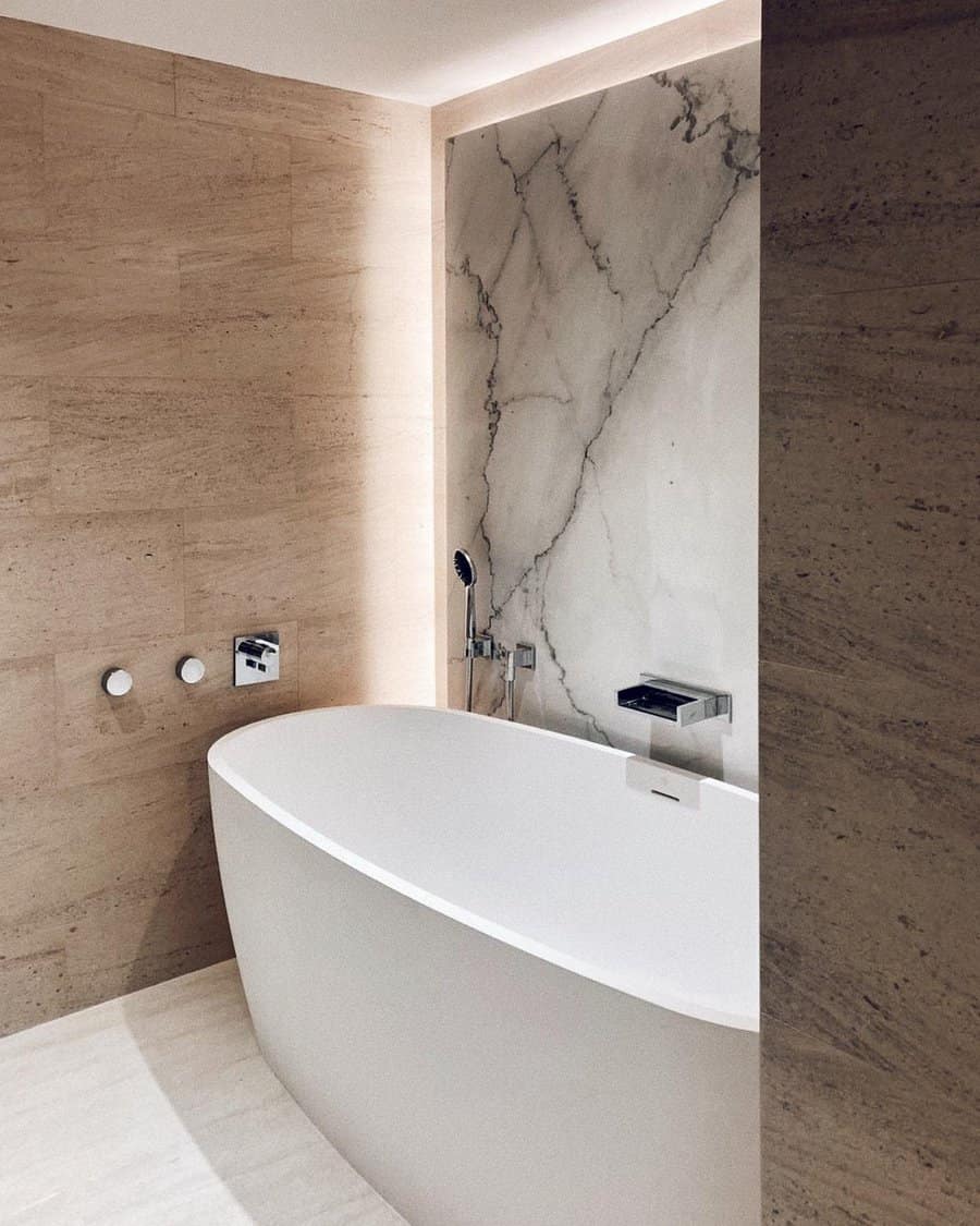 Minimalist bathroom with freestanding tub and marble wall