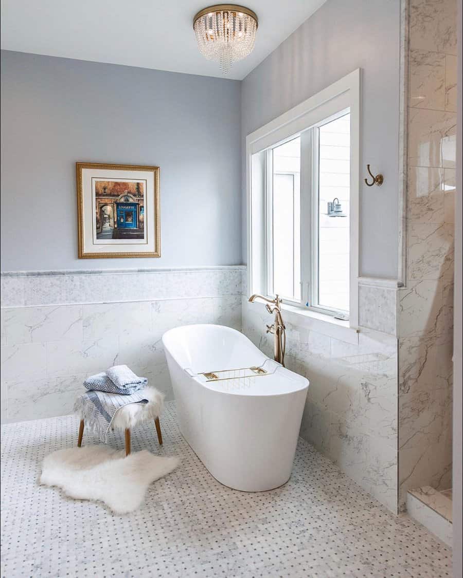 Chic bathroom with gold fixtures and freestanding tub