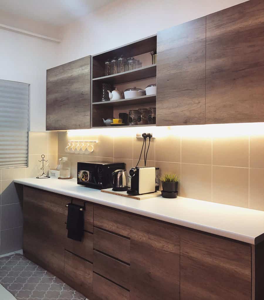 Modern kitchen with wooden cabinets, countertop appliances, and under-cabinet LED lighting