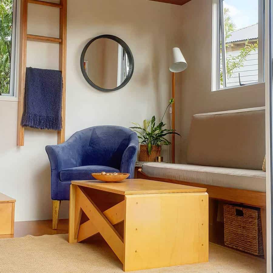 Minimalist living room with blue armchair and wooden details