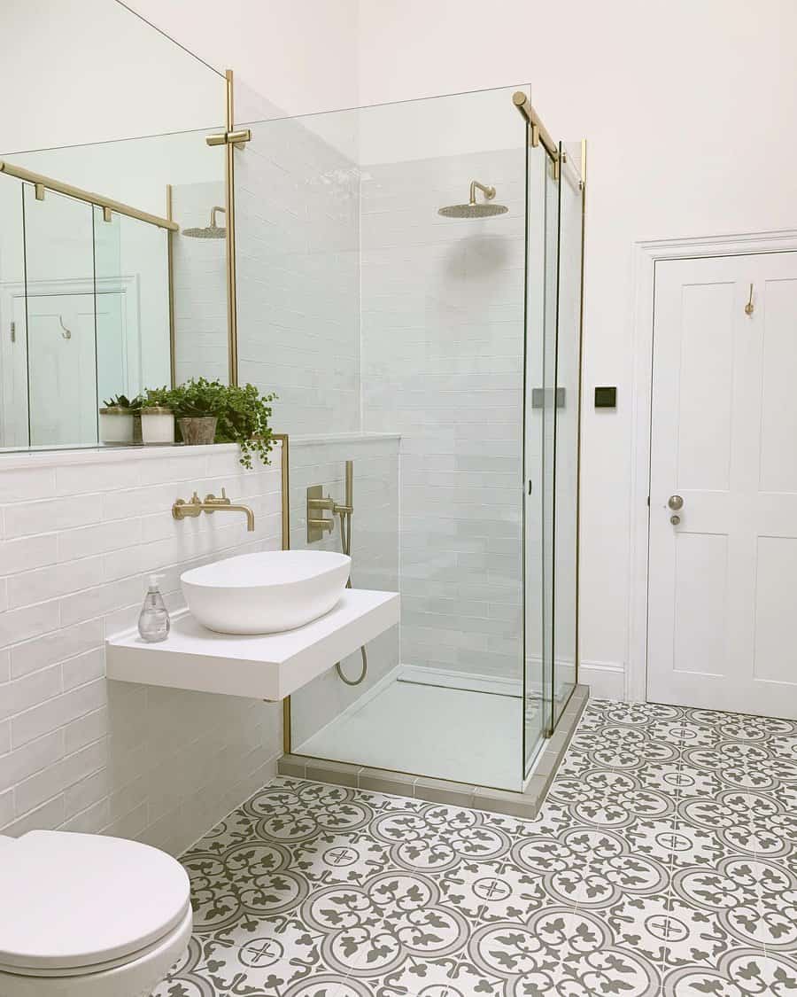 walk-in shower with gold fixtures