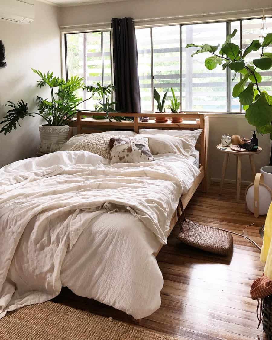 Minimalist Zen bedroom with a wooden bed frame, soft linen bedding, abundant greenery, and natural light for a peaceful, nature-inspired retreat