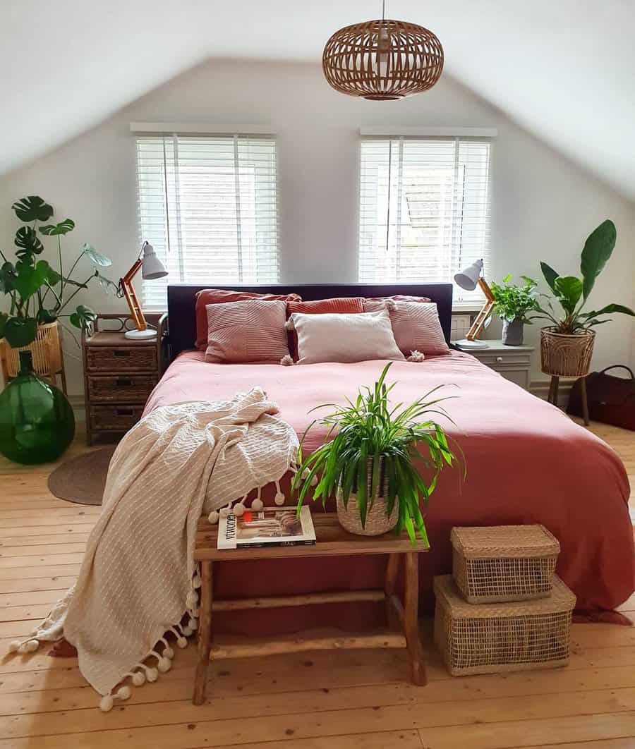Loft bedroom with vibrant bedding and greenery