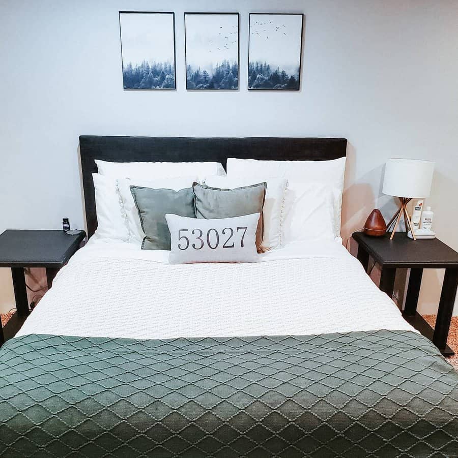 Modern bedroom with forest artwork and layered bedding