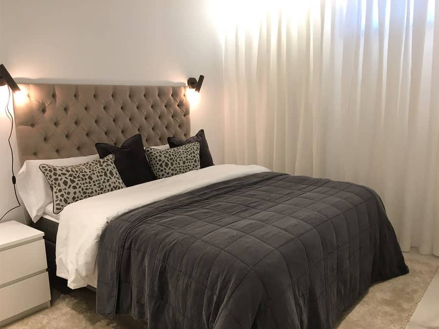 Elegant bedroom with tufted headboard and chic bedding