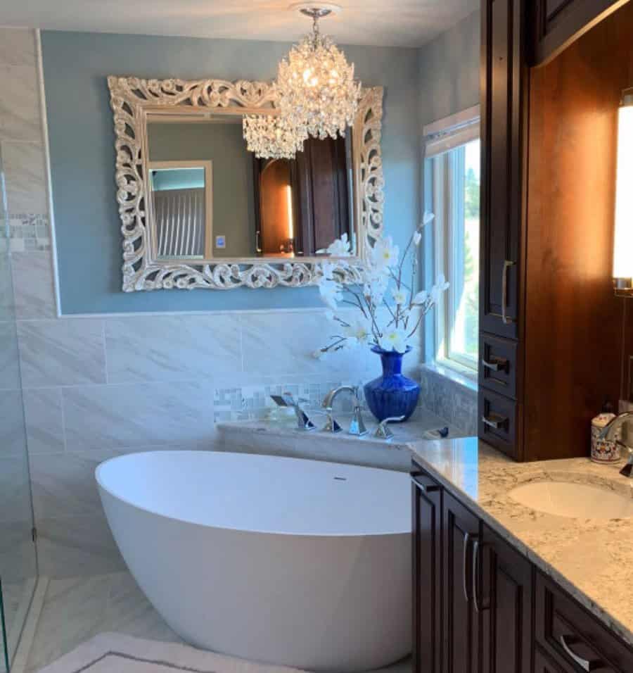 Elegant bathroom with ornate mirror and chandelier