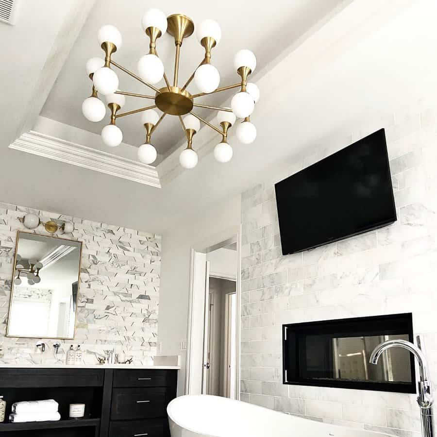 Modern bathroom with sputnik chandelier and marble wall