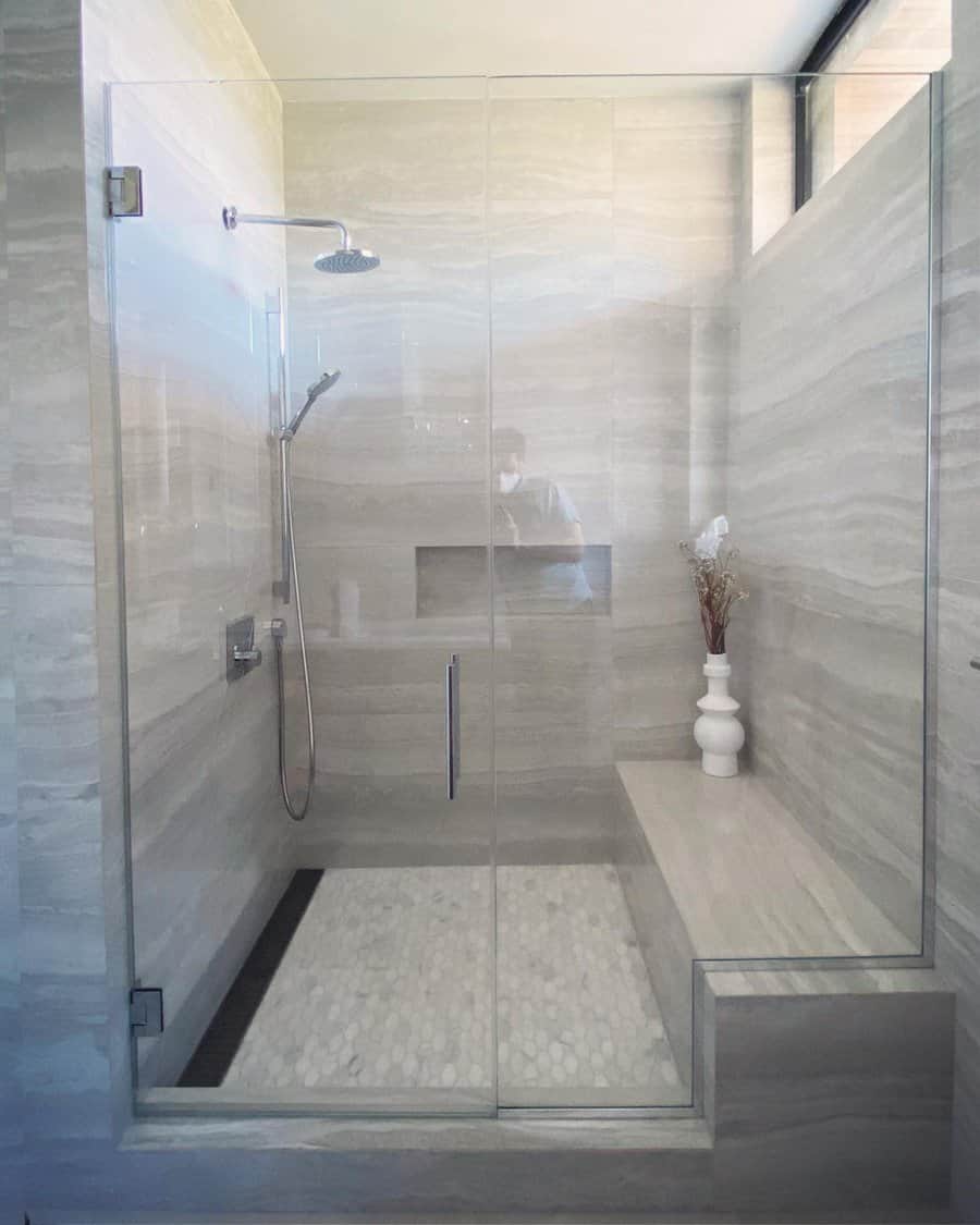 bathroom shower with stone-patterned flooring