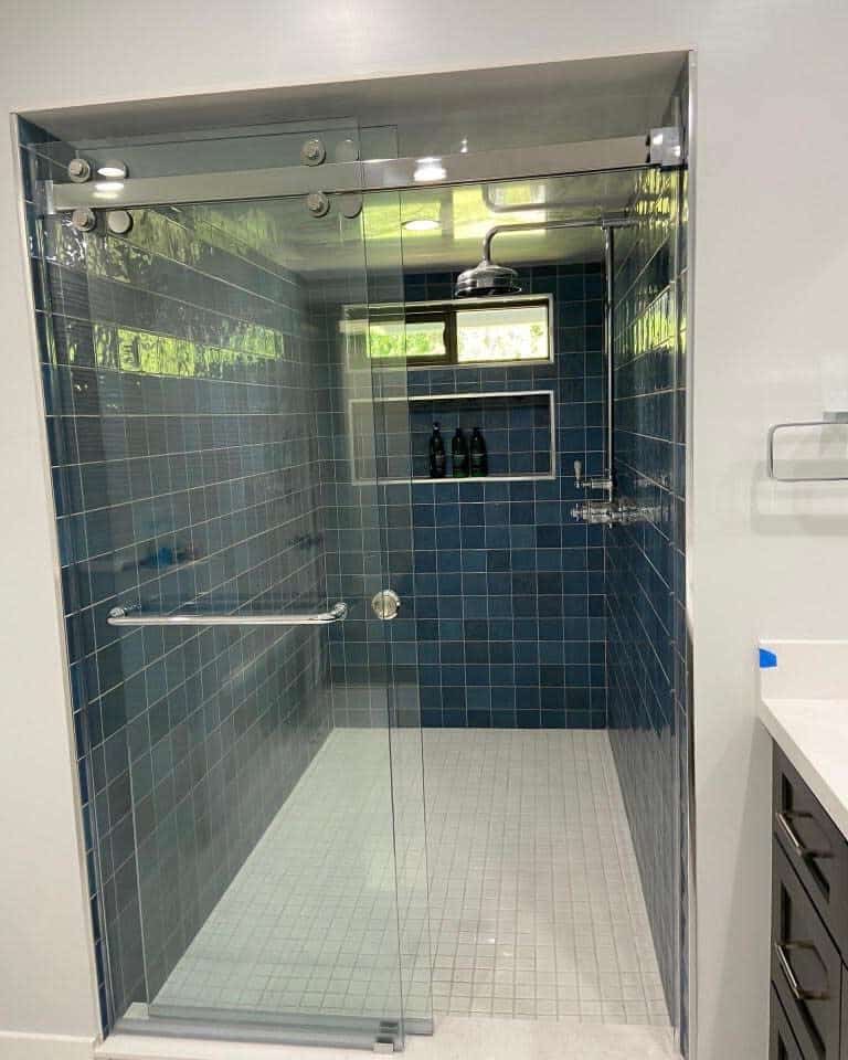 bathroom shower with blue glass tiles 