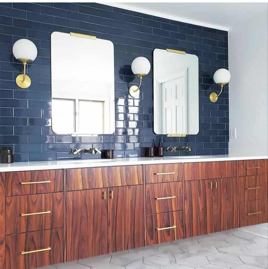 double bathroom vanity with subway accent tiles and wall sconces