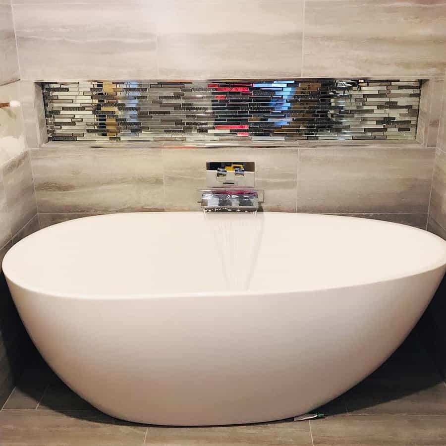 Contemporary tub with mosaic tile feature wall