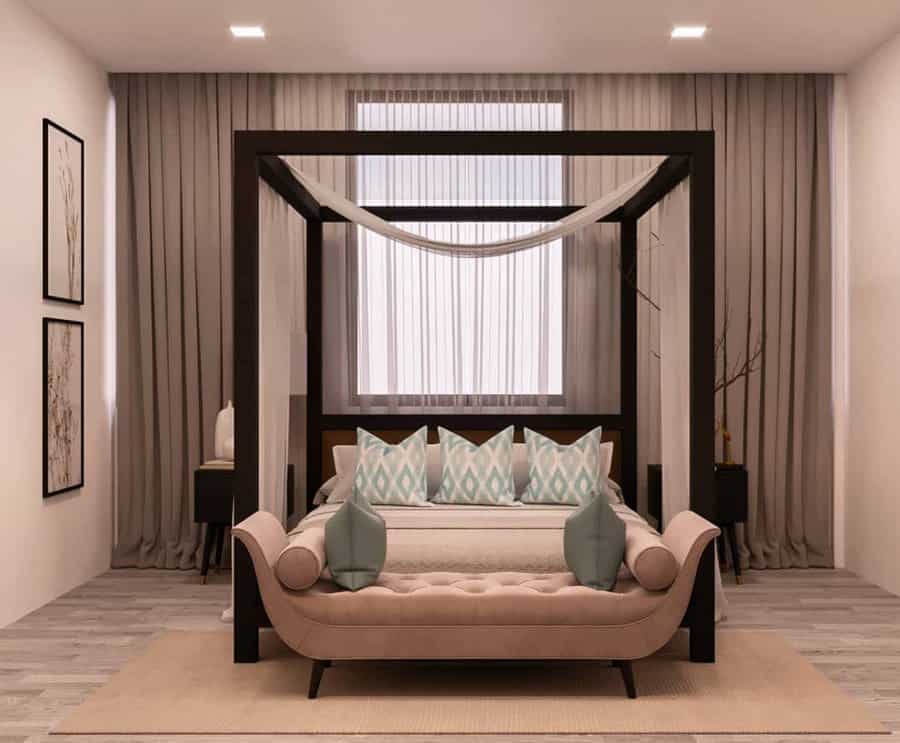 Modern canopy bed with a sleek dark wood frame, sheer drapes, soft neutral bedding, and a tufted bench for an elegant and relaxing bedroom retreat