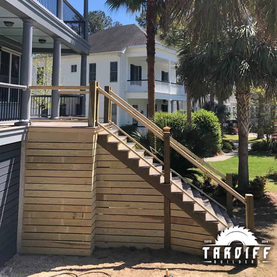 Staircase with horizontal deck skirting and classic house backdrop