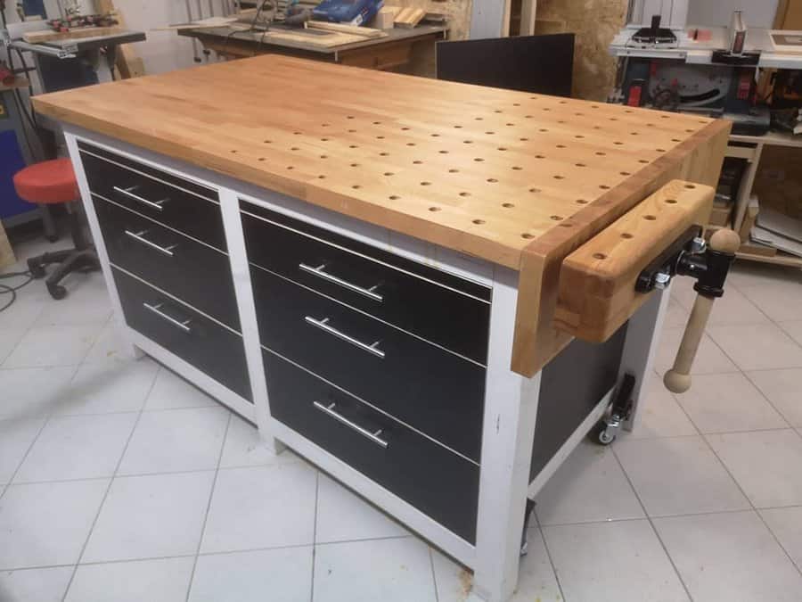 Wooden workbench with vise and drawers in a workshop