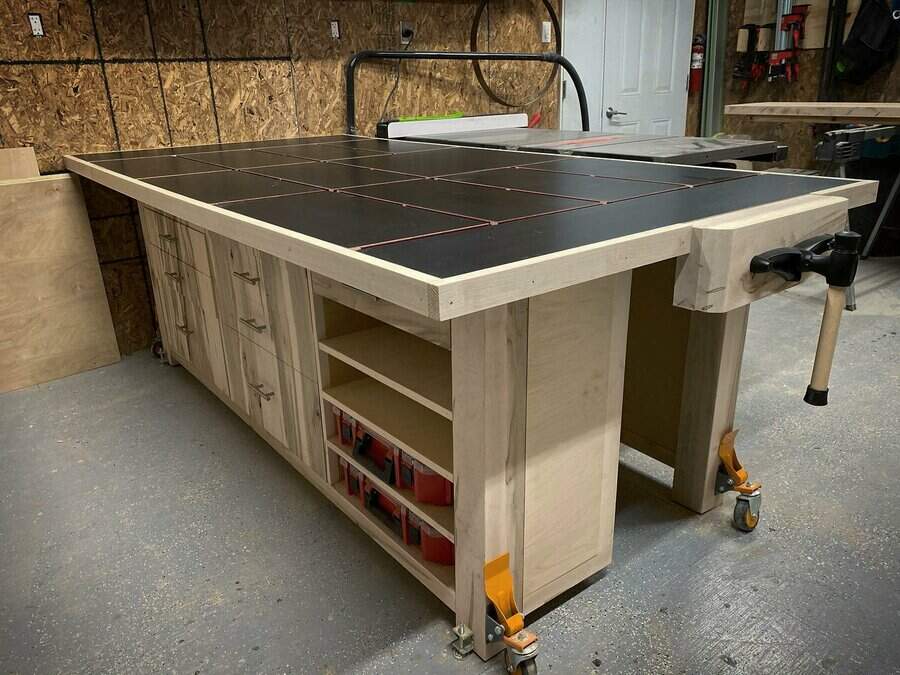 Mobile workbench with black top and storage shelves