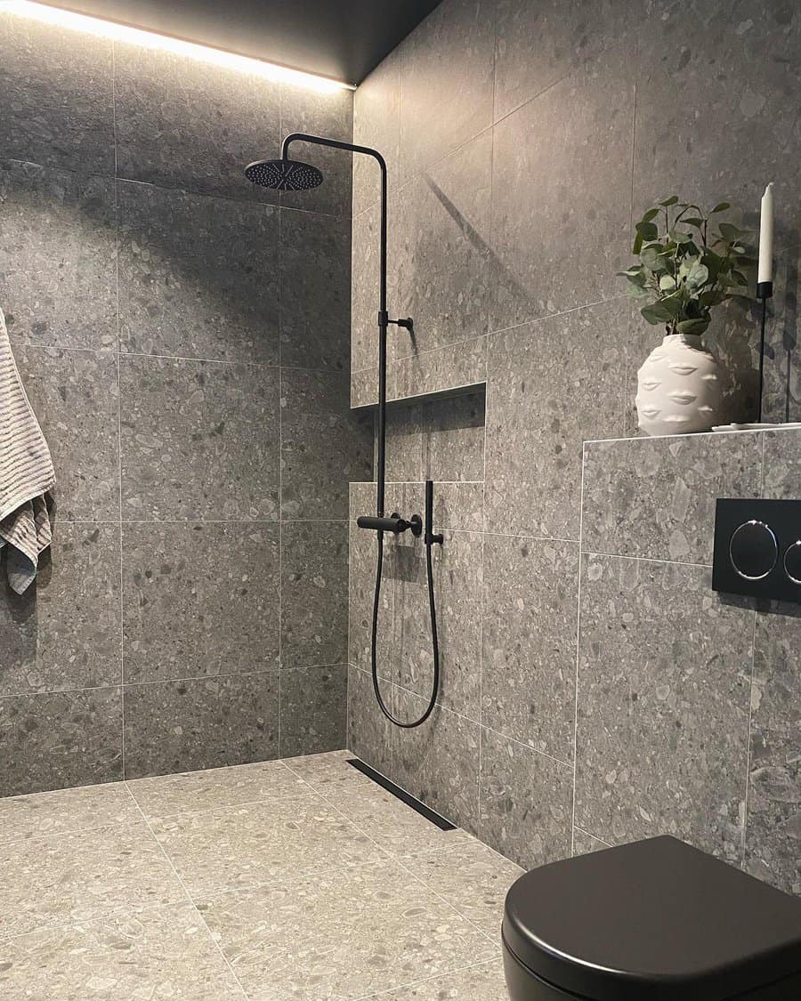 Contemporary shower with terrazzo tiles and plants