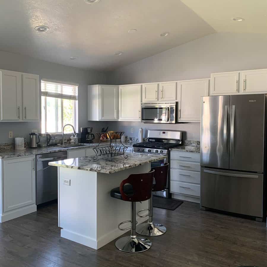 Modern white kitchen with grey granite countertops