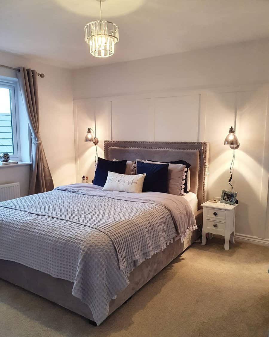 Inviting bedroom with elegant pendant light and paneled headboard