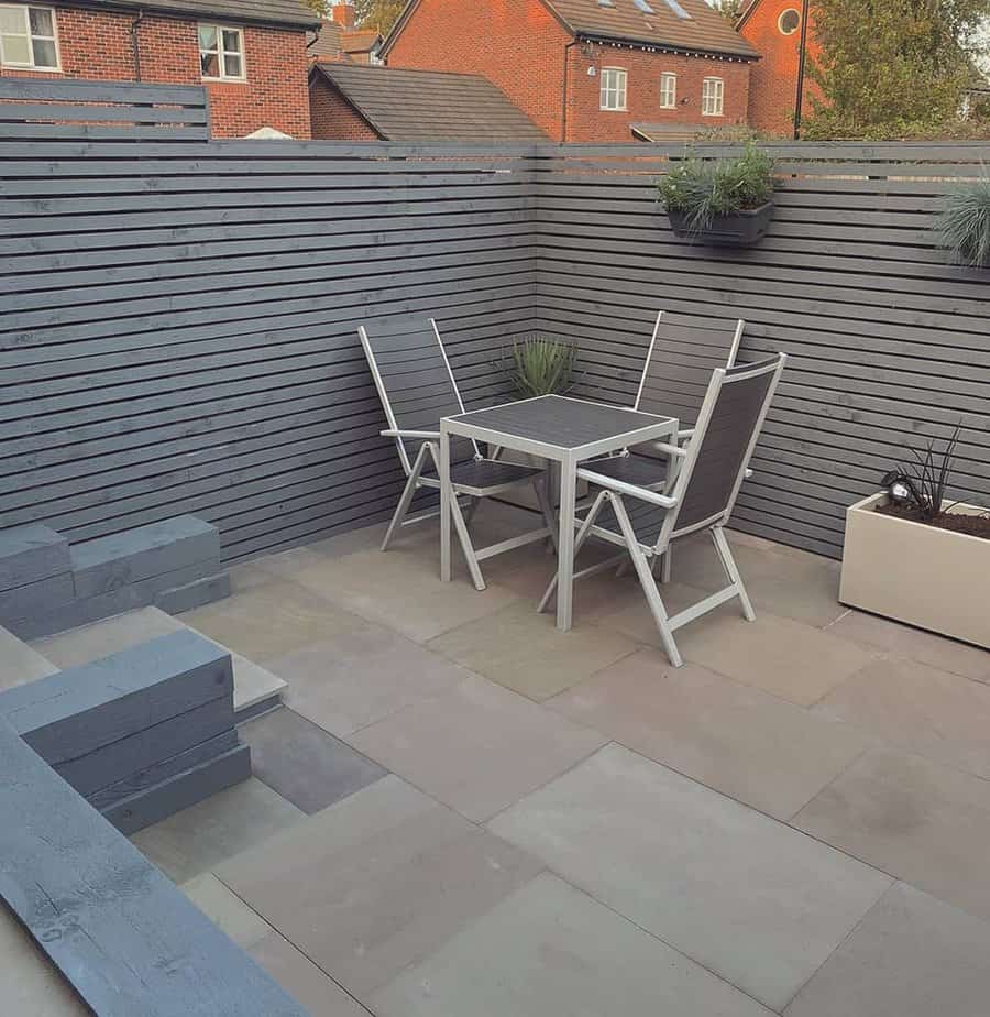 Cozy patio setup with gray fence